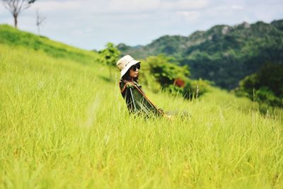 Full length of person wearing hat on field