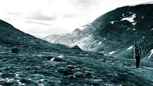 Scenic view of mountains against cloudy sky