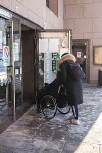 Carer pushing woman on wheelchair