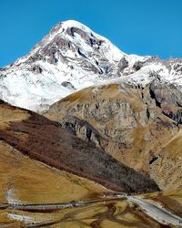 Scenic view of snowcapped mountains against clear sky