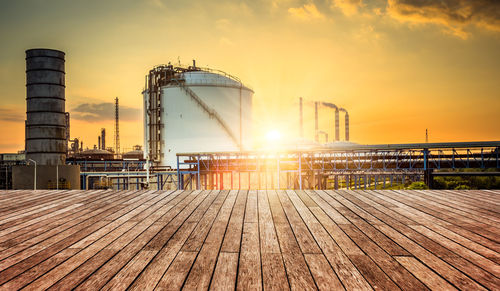 View of factory against sky during sunset