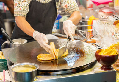 Midsection of woman preparing food on table