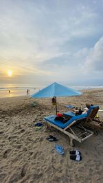 Scenic view of beach against sky during sunset