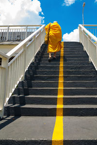 Low angle view of yellow umbrella on steps