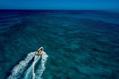 High angle view of motorboat sailing on sea against sky