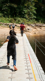 Rear view of people walking on footpath