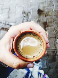 Close-up of hand holding coffee cup