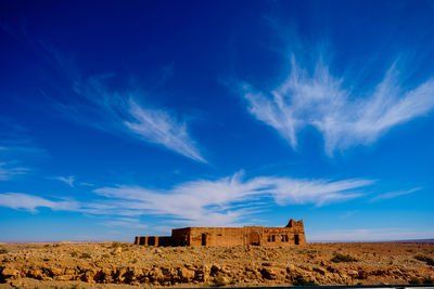 Scenic view of field against blue sky