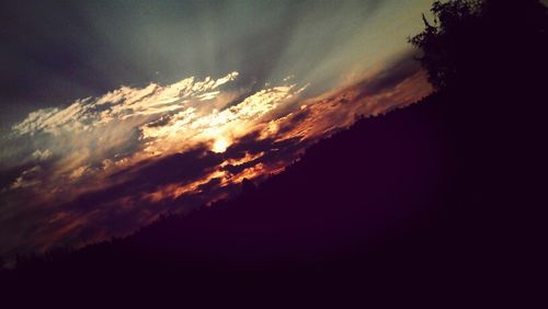 Silhouette of landscape against cloudy sky