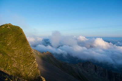 Scenic view of mountains against cloudy sky