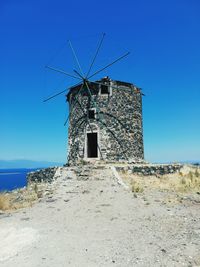 Traditional windmill against clear blue sky