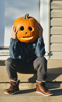 Low section of man with jack o lantern