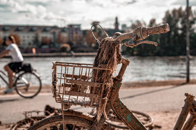 View of abandoned bicycle by river in city