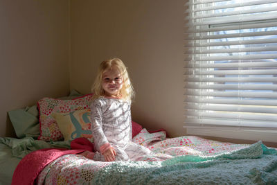 Cute girl on bed at home