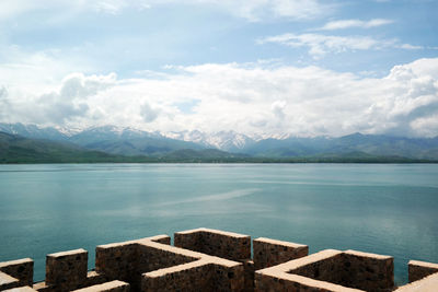 Scenic view of lake against cloudy sky