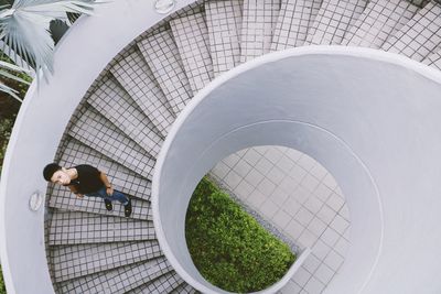High angle view of man standing on spiral staircase
