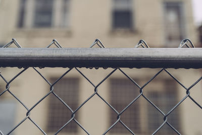 Close-up of chainlink fence against sky