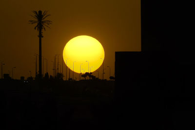 Silhouette palm trees against clear sky during sunset