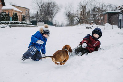 Outdoor winter activities for kids. kids playing in the suburbs, winter backyard gathering. boys
