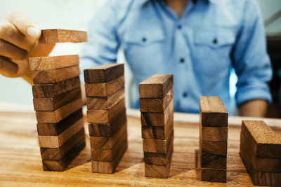 Close-up of man playing on table