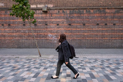 Full length of woman walking on footpath