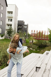 Father carrying daughter on his back