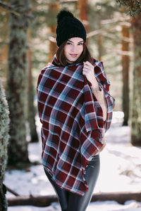 Portrait of young woman standing outdoors