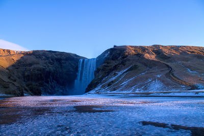 Scenic view of mountain against clear blue sky