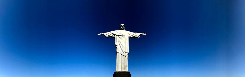 Low angle view of statue against blue sky