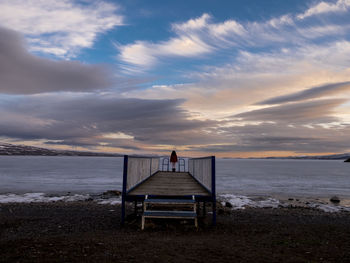 Scenic view of beach against cloudy sky