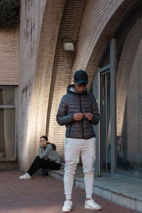 Rear view of young man standing in tunnel