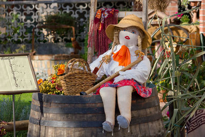 Full length of boy sitting on wicker basket