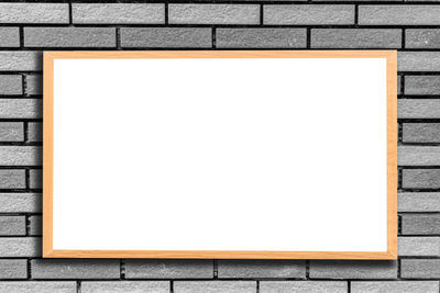 Blank placard mounted on gray wall