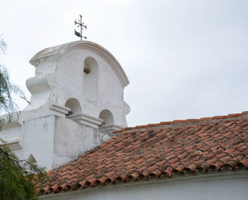 Low angle view of building roof against sky