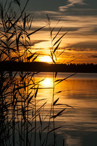 Scenic view of lake against orange sky