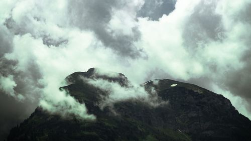 Low angle view of volcanic mountain against sky