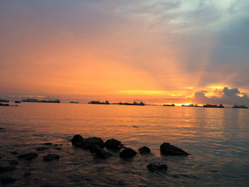 Scenic view of sea against romantic sky at sunset