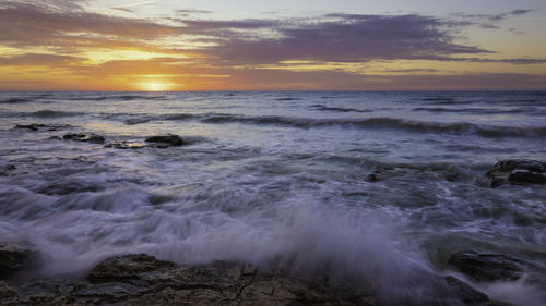 Scenic view of sea against sky during sunset