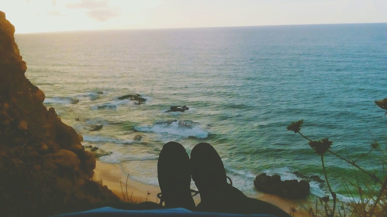 sea, water, horizon over water, nature, scenics, beauty in nature, tranquil scene, tranquility, rock - object, sky, outdoors, two people, low section, sitting, real people, beach, men, day