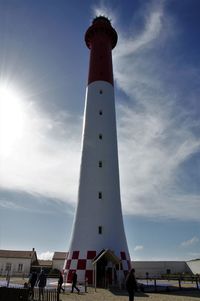 Low angle view of lighthouse against buildings