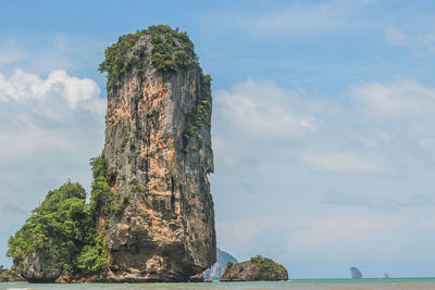 Rock formation in sea against sky