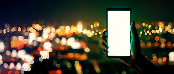 Close-up of illuminated lights in city at night