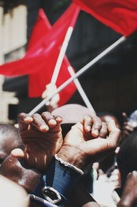 Close-up of mid adult man covering face with hands in protest