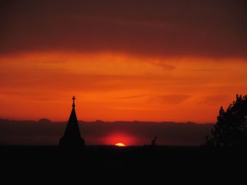 Silhouette temple against sky during sunset