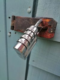 Close-up of combination padlock attached to door