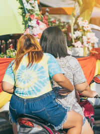 Rear view of women sitting in traditional clothing