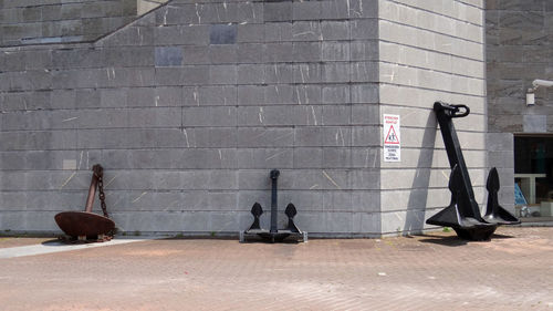 People walking on footpath against building