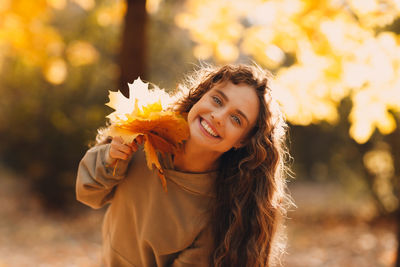 Portrait of young woman holding flower