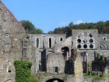 Old ruin abbey building against clear sky