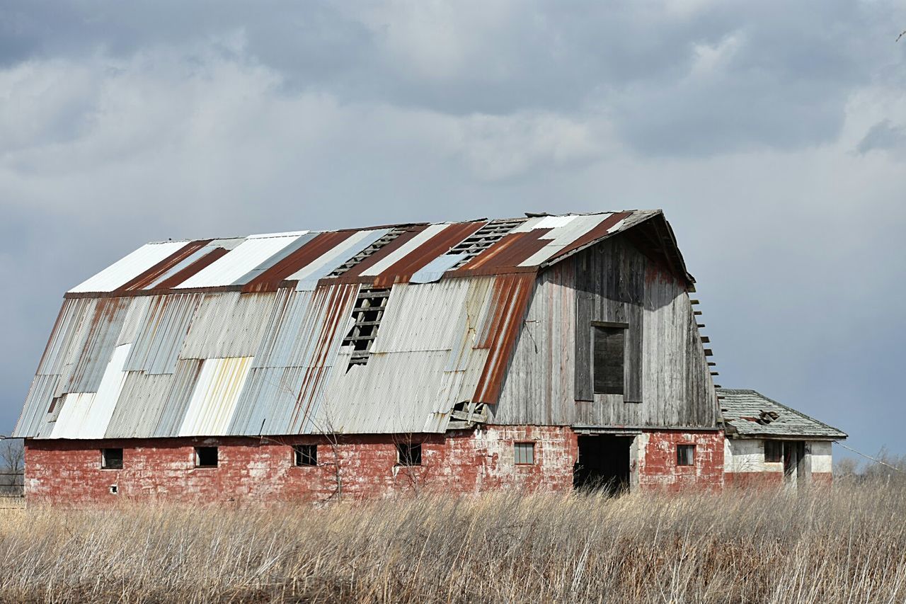 ABANDONED BARN ON FIELD AGAINST SKY